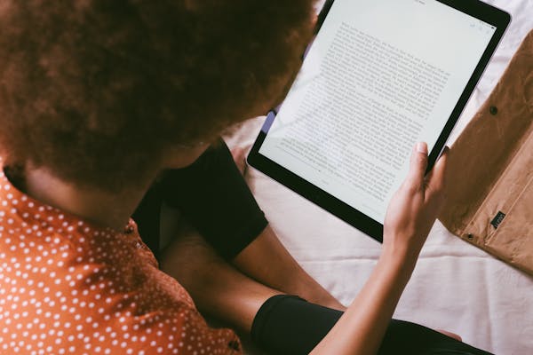 Person reading the ebook Xarevās Azyk, an enchanting artificial language inspired by Croatian and Slavic influences.