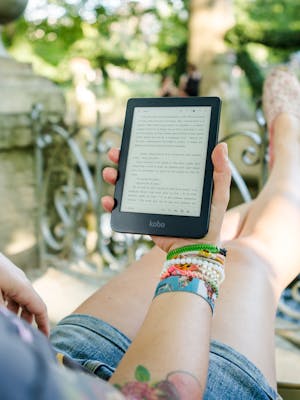 Person Holding Person Holding Kobo E-reader