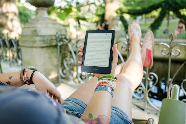 Person Holding Person Holding Kobo E-reader